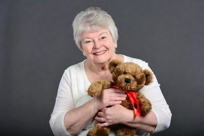Elderly woman holding teddy bear