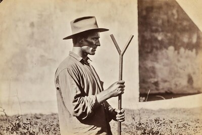 Man holding Y-shaped stick