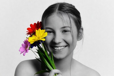 Smiling girl holding colorful flowers