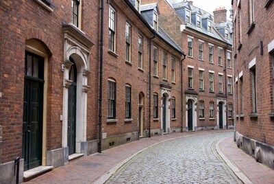 Curving Cobblestone Street with Brick Houses