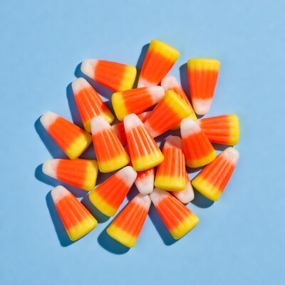 Candy corn pile on blue background