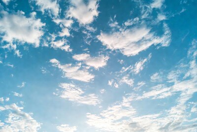 Fluffy white clouds in blue sky