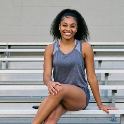 Smiling African-American girl on bleachers