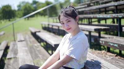 Asian girl smiling on bleachers