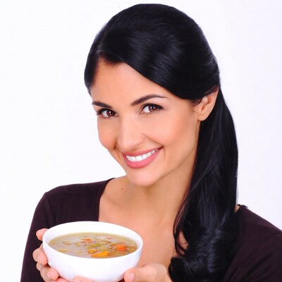 Woman holding bowl of soup