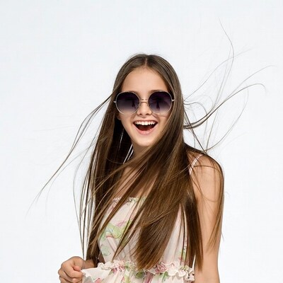 Girl smiling with round sunglasses