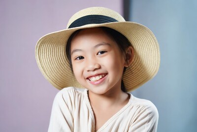 Asian girl smiling in straw hat