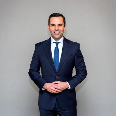 Man in navy suit smiling