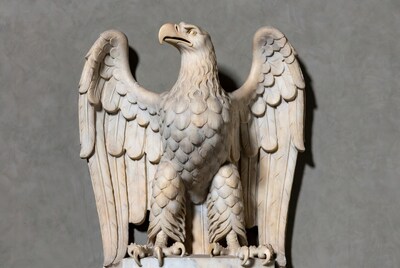 White marble eagle sculpture with wings spread