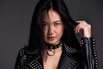 Asian woman in spiked leather jacket