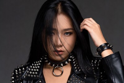 Asian woman in spiked leather jacket