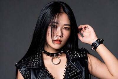 Asian woman in spiked leather vest