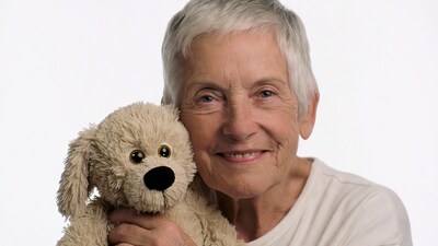 Elderly woman holding teddy dog