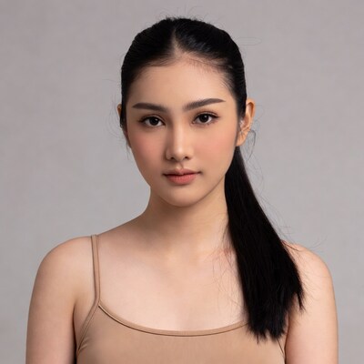 Asian woman in beige camisole ponytail