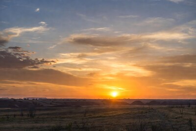Sunset over grassy hills and fields