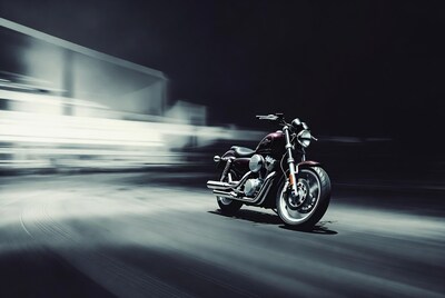 Purple motorcycle speeding at night