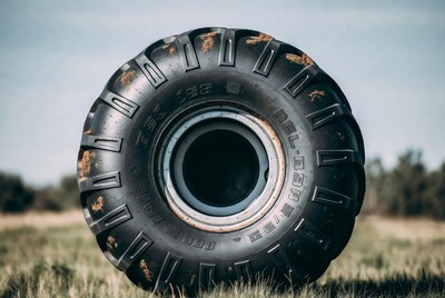 Rusty off-road tire in grass