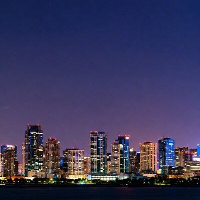 City skyline at night over water