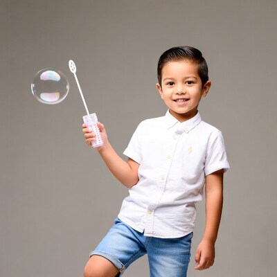 Asian boy blowing bubbles