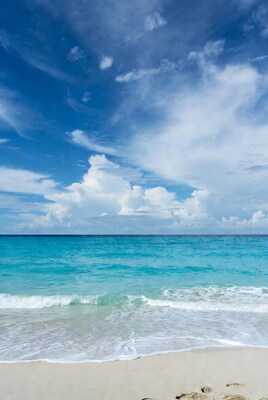 Turquoise Ocean Beach with Footprints