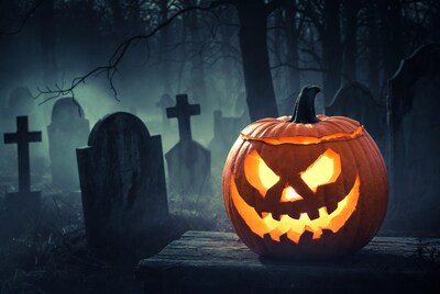 Jack-o'-lantern in foggy graveyard