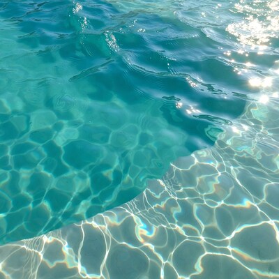 Turquoise Pool Water with Sunlight Reflections