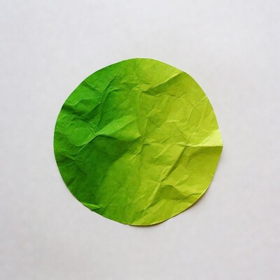 Green crumpled paper circle