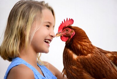 Girl nose-to-nose with hen