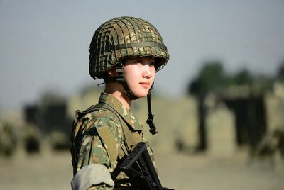 Asian woman soldier with rifle