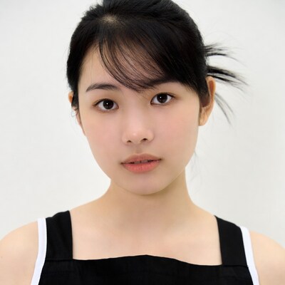 Asian woman in black apron