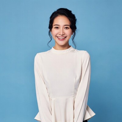 Asian woman smiling in white dress