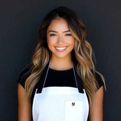 Smiling Asian woman in white apron