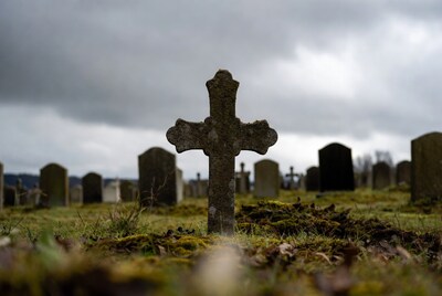 Mossy Cross in Foggy Cemetery