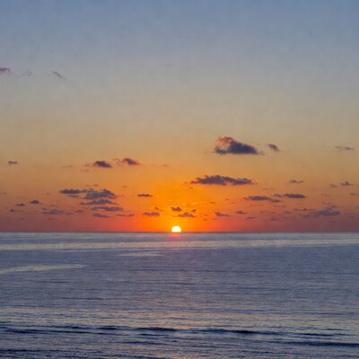 Sunset over ocean with clouds
