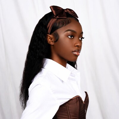Black woman in brown bow headband and corset