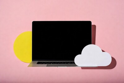 Laptop with yellow sun and white cloud