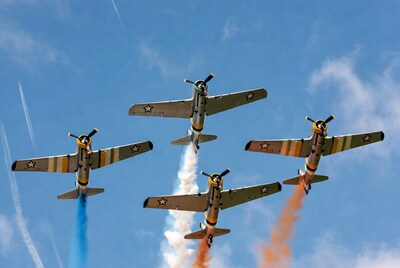 P-51 Mustangs flying with colored smoke trails