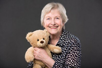Elderly woman hugging teddy bear