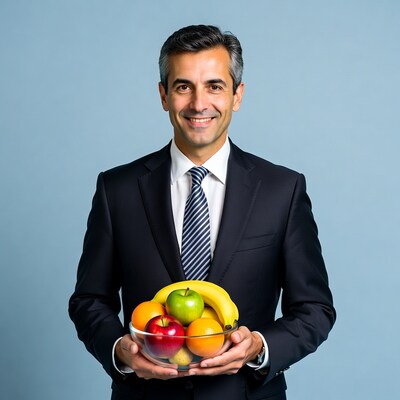 Man in suit holding fruit bowl