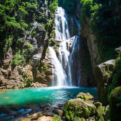 Majestic waterfall cascading into turquoise pool