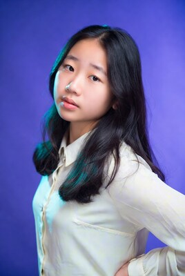 Asian girl in white shirt on purple background