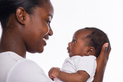 African-American mother holding smiling baby