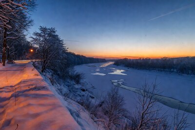Frozen River Sunset with Snowy Trees