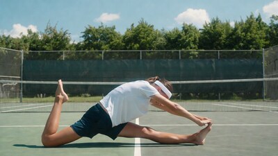 Woman stretching on tennis court