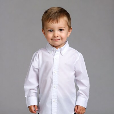 Smiling toddler boy in white shirt