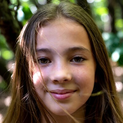 Girl smiling in green forest