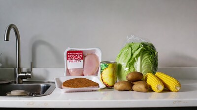 Chicken fillets potatoes corn lettuce on counter