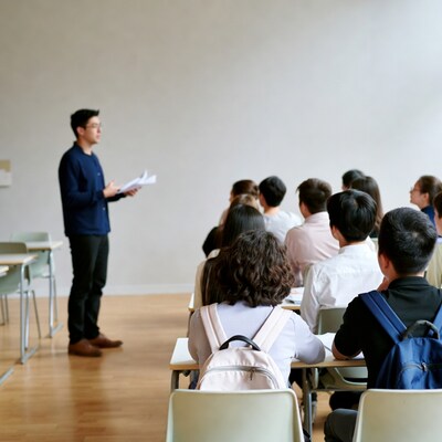 Asian teacher lecturing students in classroom