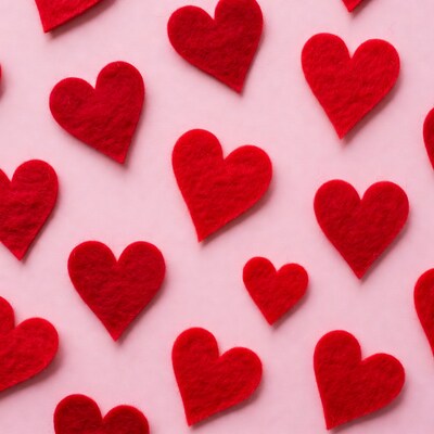 Red Felt Hearts on Pink Background