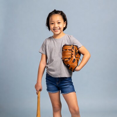 Asian girl with baseball glove and bat